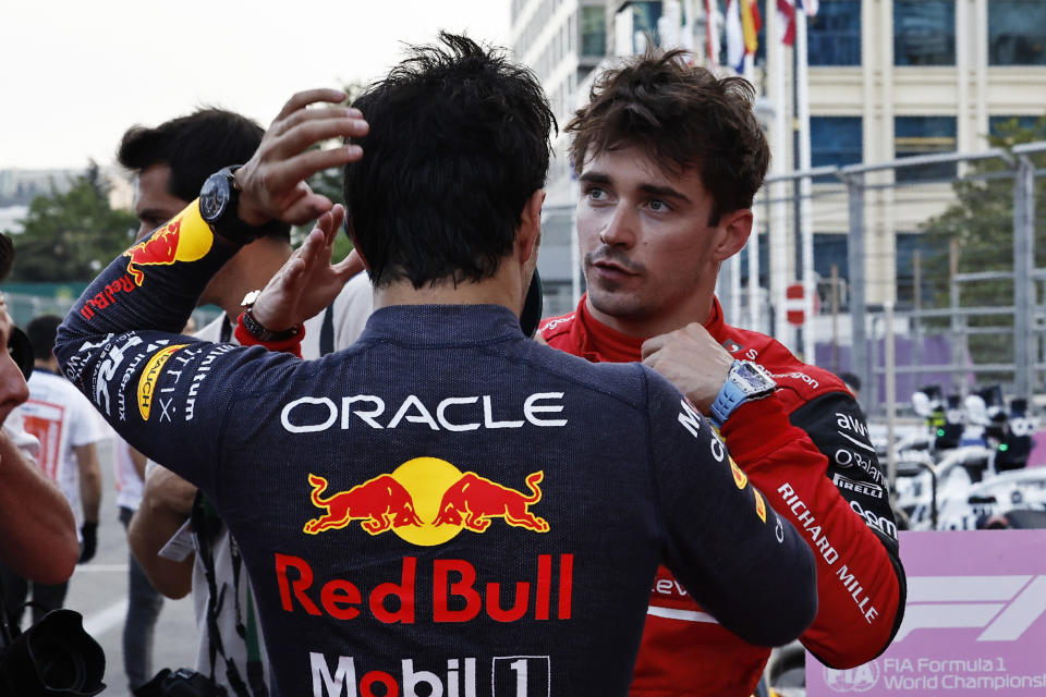 Ferrari driver Charles Leclerc of Monaco talks with Red Bull driver Sergio Perez of Mexico after setting the pole position in the qualifying session at the Baku circuit, in Baku, Azerbaijan, Saturday, June 11, 2022. The Formula One Grand Prix will be held on Sunday. (Hamad Mohammed, Pool Via AP)