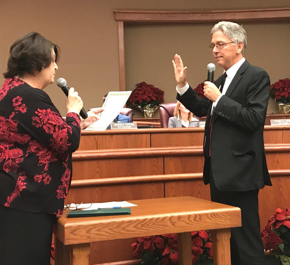 City Clerk Pam Mize gives the oath of office to then new Redding City Council member Michael Dacquisto in 2018.