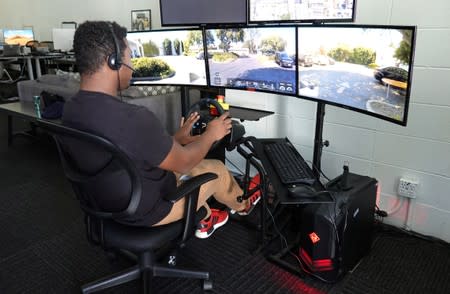 Remote operator Magi Frazier guides a self-driving vehicle from a console at the Silicon Valley headquarters of software supplier Phantom Auto in Mountain View