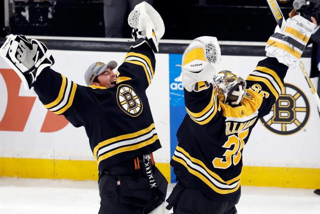 Boston Bruins goalies Linus Ullmark (35) and Jeremy Swayman celebrate after the victory over the New Jersey Devils.