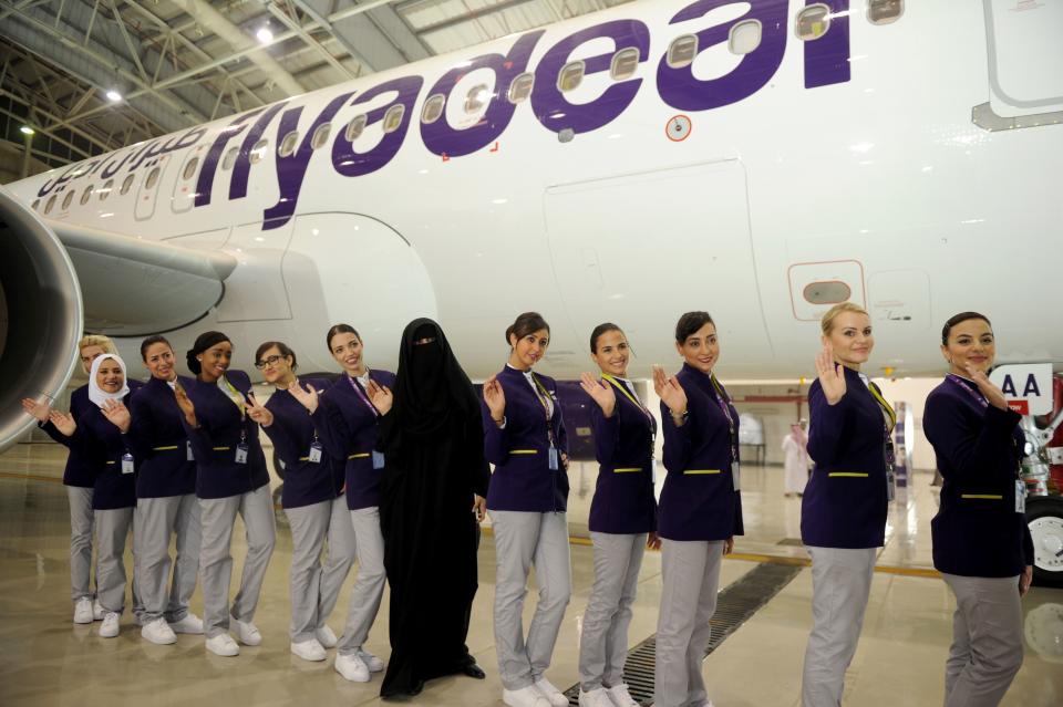 Asian Sadaf Khan (C), the designer of hostesses, uniforms poses for picture with hostesses of the new Fly company during the launching ceremony held at the King Abdulaziz airport in the coastal city of Jeddah, on August 25, 2017.
Saudi Arabia's new budget carrier Flyadeal said Thursday it will start flying next month, as the kingdom seeks to expand air services to boost tourism in a radical overhaul of its oil-dependent economy. / AFP PHOTO / AMER HILABI        (Photo credit should read AMER HILABI/AFP via Getty Images)