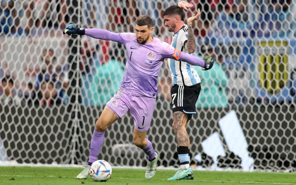 Mathew Ryan of Australia defends the ball against Rodrigo De Paul of Argentina during the FIFA World Cup Qatar 2022 Round of 16 match between Argentina and Australia at Ahmad Bin Ali Stadium - Getty Images