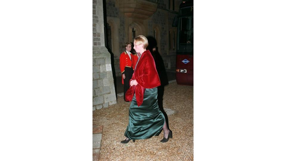 Zara Tindall in a green velvet dress and red velvet shawl