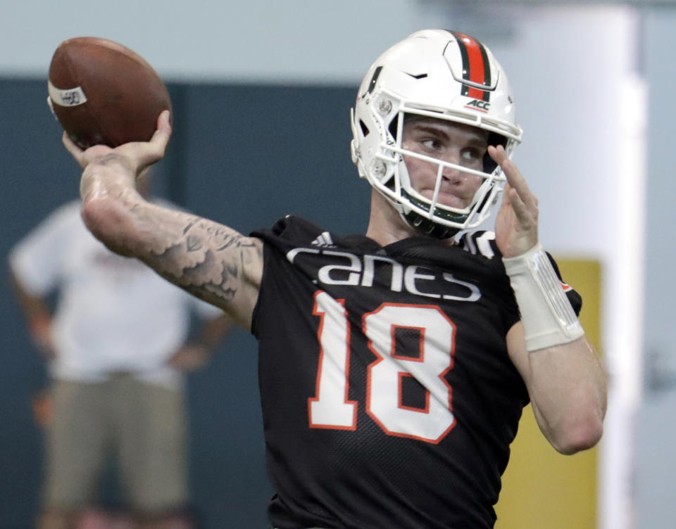 FILE - In this April 18, 2019, file photo, Miami quarterback Tate Martell (18) throws during NCAA college football spring practice, in Coral Gables, Fla. A string of recent high-profile transfers gave the college football world the impression it was getting easier for players to switch schools and compete right away. Martell to Miami, Shea Patterson to Michigan and Justin Field to Ohio State seemed to usher in a new era of free agency, but waiver approvals are still far from a sure thing. That is prompting athletes, coaches and others to complain about a process that can be somewhat mysterious. (AP Photo/Lynne Sladky, File)