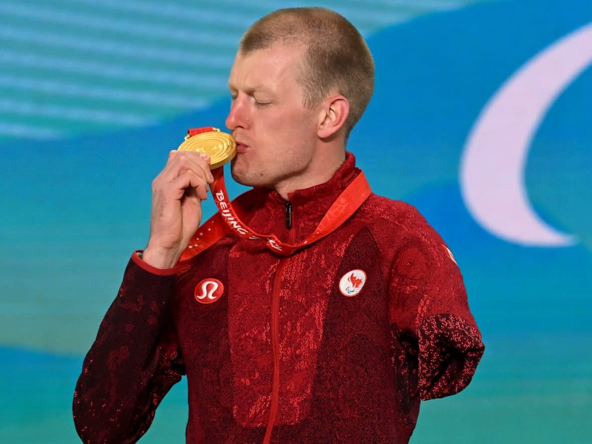 Canadian Paralympian Mark Arendz celebrates his gold in the biathlon middle distance standing event at the Beijing Olympics, one of 10 medals he has won in his Paralympic career. (Getty Images for International P - image credit)