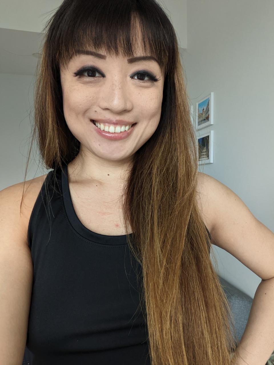 <p>A picture from the Pixel 6a's front camera, featuring a woman smiling, with her hand on her hip.</p>
