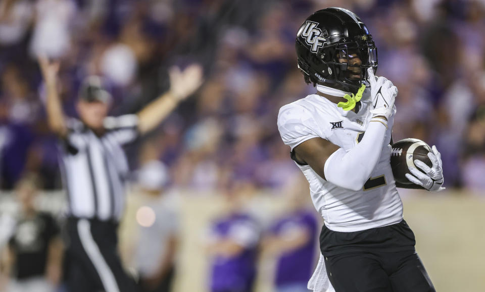 Central Florida wide receiver Kobe Hudson quiets the Kansas State crowd after scoring a touchdown on a trick play during the first half of an NCAA college football game on Saturday, Sept. 23, 2023, in Manhattan, Kan. (AP Photo/Travis Heying)