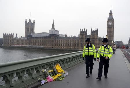 Flowers are placed at the scene of an attack on Westminster Bridge, in London, Britain March 24, 2017. REUTERS/Darren Staples