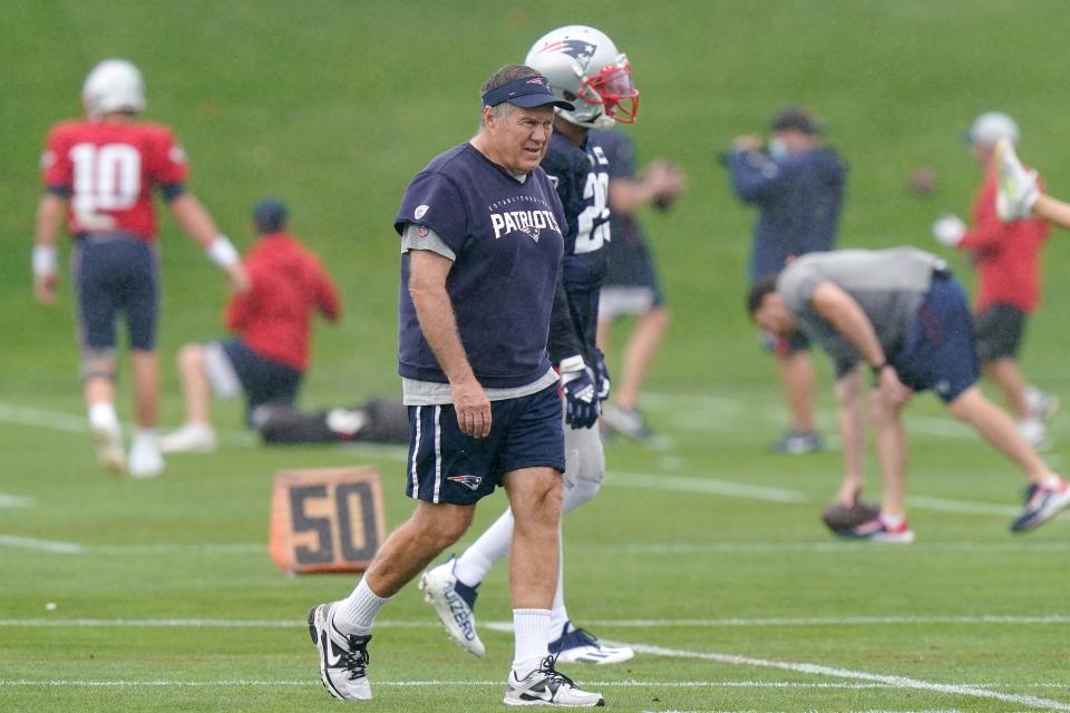 New England Patriots head coach Bill Belichick, front, walks on the field during an NFL football practice, Wednesday, Sept. 22, 2021, in Foxborough, Mass. (AP Photo/Steven Senne)