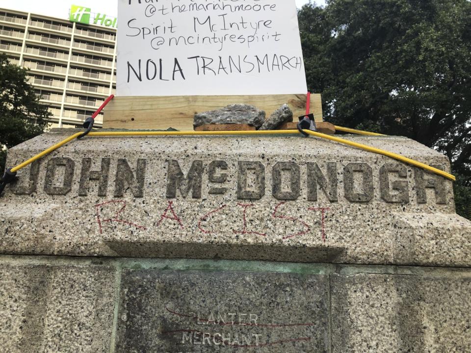 Demonstrators in New Orleans wrote "racist" and pulled down the bust of John McDonogh, a slave owner.