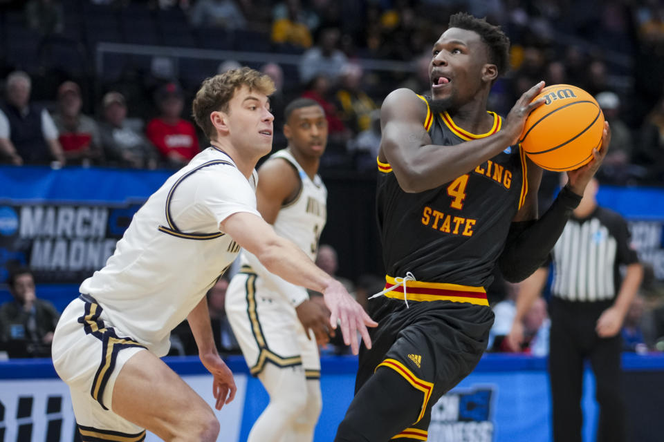 Grambling State forward Antwan Burnett, right, drives to the basket against Montana State guard Tyler Patterson, left, during the first half of a First Four game in the NCAA men's college basketball tournament Wednesday, March 20, 2024, in Dayton, Ohio. (AP Photo/Aaron Doster)