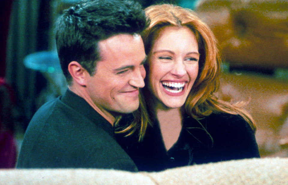 Matthew Perry and Julia Roberts hug each other on the set of 