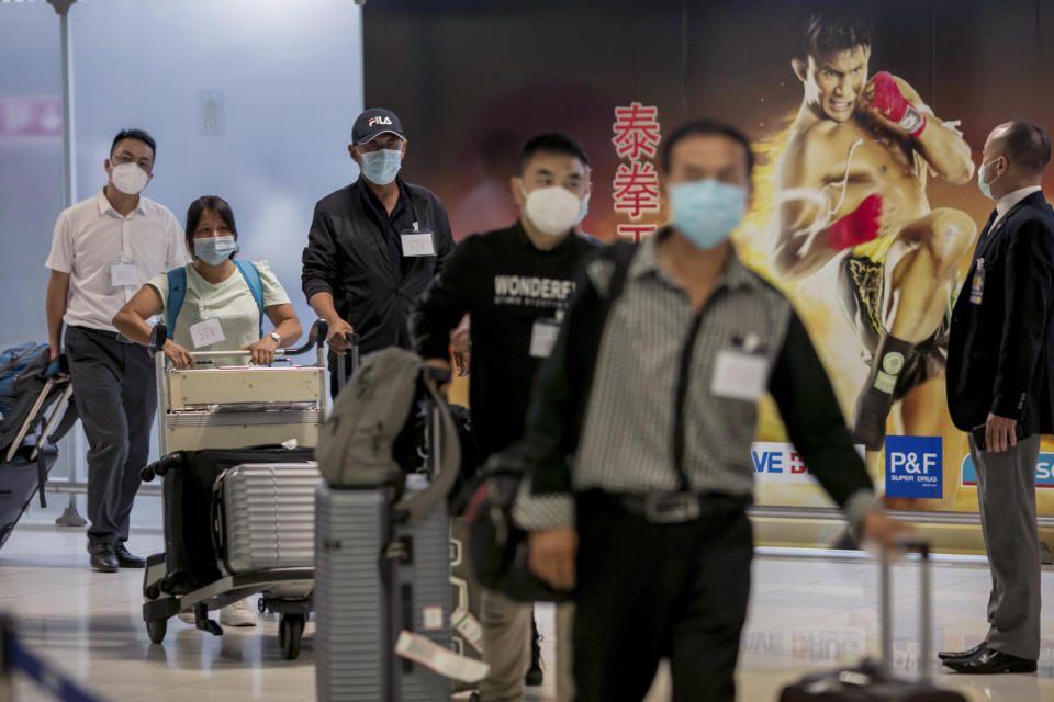 Chinese tourists from Shanghai arrive at Suvarnabhumi airport on special tourist visas, in Bangkok, Thailand, Tuesday, Oct. 20, 2020. Thailand on Tuesday took a modest step toward reviving its coronavirus-battered tourist industry by welcoming 39 visitors who flew in from Shanghai, the first such arrival since normal traveler arrivals were banned almost seven months ago. (AP Photo/Wason Wanichakorn)