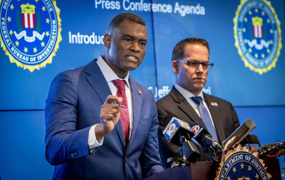 U.S. Attorney for the Southern District of Florida Markenzy Lapointe, left, talks to reporters as FBI Miami Special Agent in Charge Jeffrey B. Veltri, right, stands by during a press conference to address developments in the Sergio Pino murder-for-hire investigation at FBI Miami Headquarters in Miramar, Florida, on Wednesday, July 17, 2024.