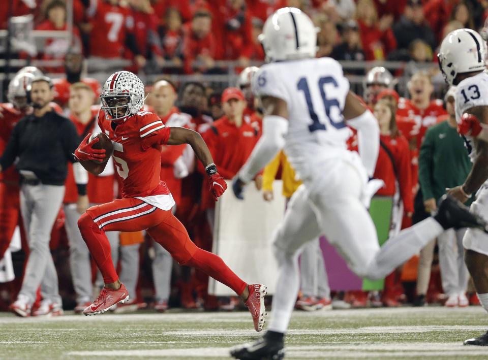 Ohio State Buckeyes wide receiver Garrett Wilson (5) carries the ball after a catch against Penn State Nittany Lions during the first quarter of their game at Ohio Stadium in Columbus, Ohio on October 30, 2021. 