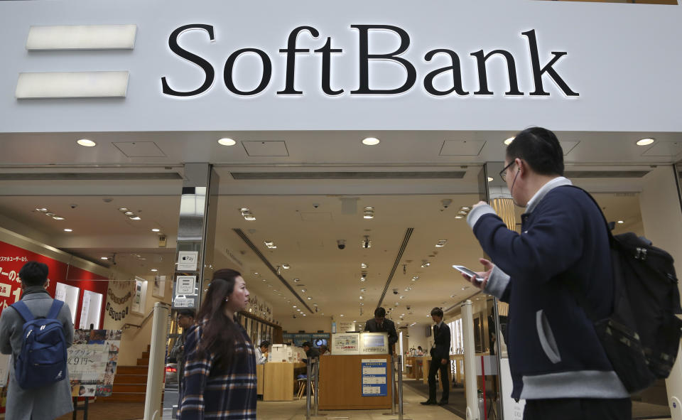 In this Dec. 4, 2017, file photo, people walk in front of Soft Bank shop in Tokyo. SoftBank Group Corp.’s Japanese mobile subsidiary has gone public in one of the world’s biggest share offerings rivaling that of China’s Alibaba Group. On Wednesday, Dec. 19, 2018, its IPO on the Tokyo Stock Exchange seeks to raise more than 2 trillion yen ($18 billion). (AP Photo/Koji Sasahara)