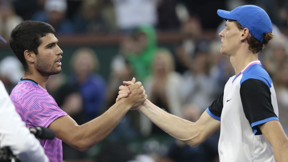 Carlos Alcaraz of Spain (L) greets Jannik Sinner of Italy (R) after winning match point during the men's semifinal match at the BNP Paribas Open in Indian Wells