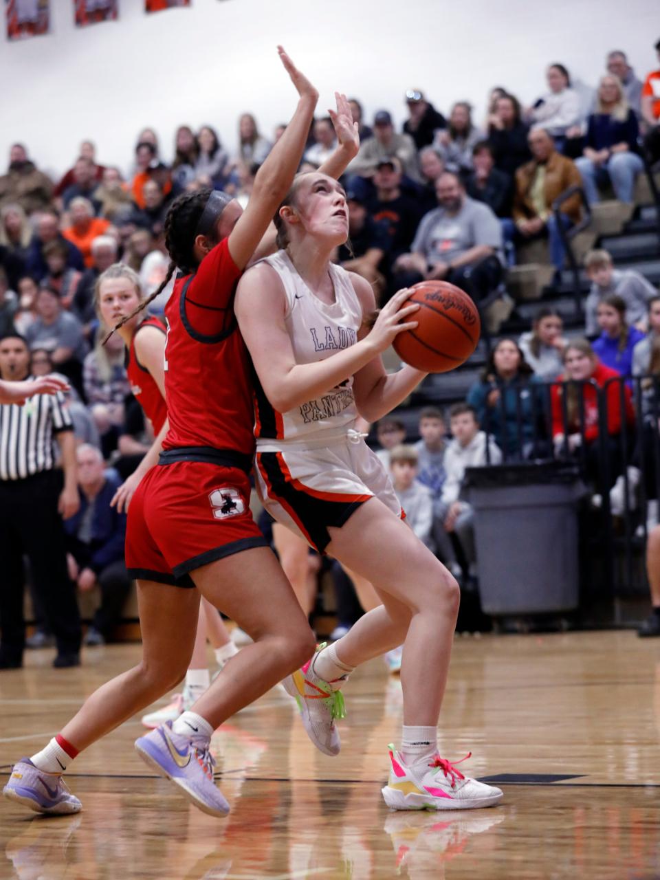 New Lexington's Abbie Wilson goes in for a shot against Sheridan's Halle Warner in last year's contest. Wilson is one of three returning starters for the Panthers, who aim to defend their MVL Small School title streak.