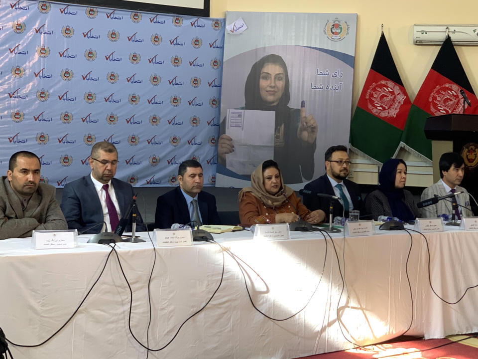 Hawa Alam Nuristani, center, chief of Election Commission of Afghanistan, speaks during a press conference in Kabul, Afghanistan, Sunday, Dec. 22, 2019. The election commission is to announce the results of the Sept. 28 election Sunday. (AP Photo/Rahmat Gul)