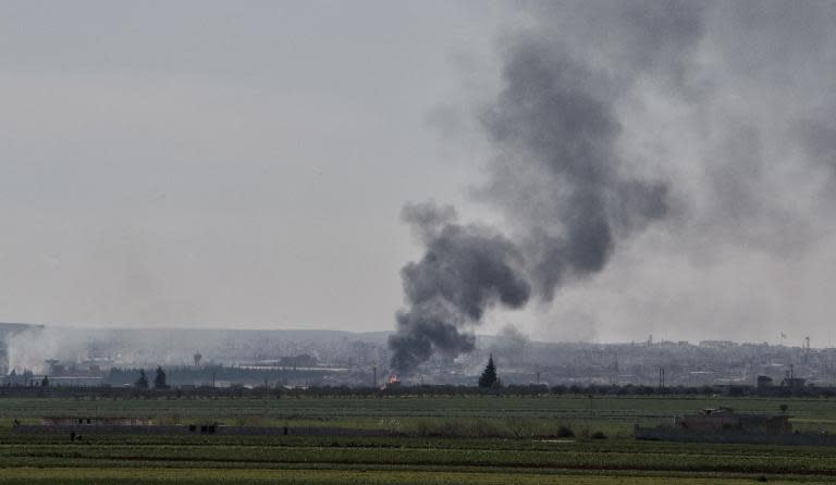 Smoke rises from the northwestern Syrian city of Idlib on March 26, 2015 following bombing by rebels
