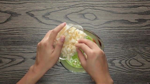 Adding chopped water chestnuts to green pandan batter