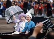 <p>The Queen Mother folds her umbrella as she and Princess Margaret participate in the Trooping the Color procession.<br></p>