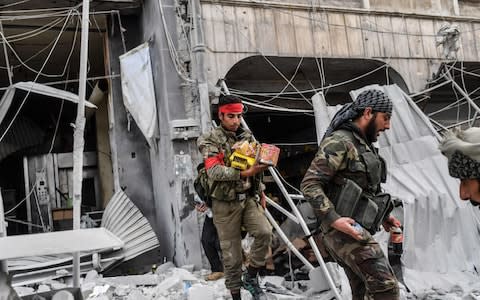 Turkish-backed Syrian Arab fighters allegedly looted shops in Afrin - Credit: BULENT KILIC/AFP/Getty Images