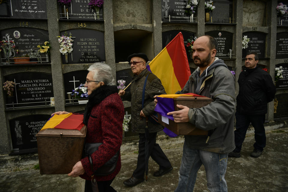 Relatives and friends carry the coffins of some of the 46 coffins of unidentified people killed during the Spanish Civil War, at San Jose cemetery, Pamplona, northern Spain, Monday, April 1, 2019. Marking eight decades since the end of the Spanish Civil War, the remains of 46 unidentified victims of the conflict have been reburied in the northern city of Pamplona. More than half a million people died in the 1936-1939 war between rebel nationalist forces led by Gen. Francisco Franco and defenders of the short-lived Spanish republic. (AP Photo/Alvaro Barrientos)