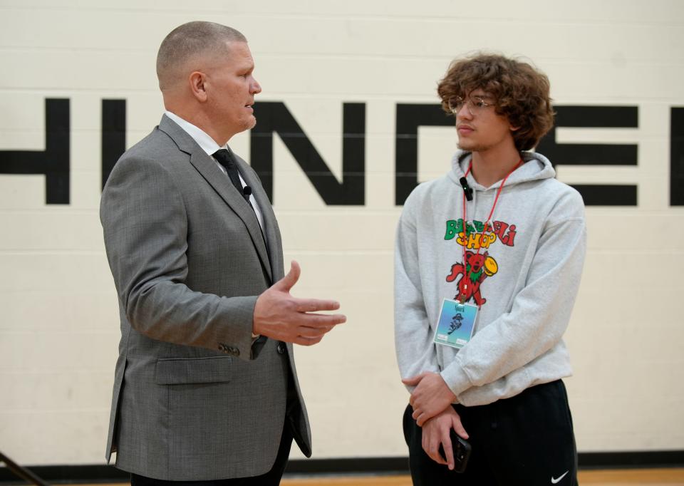 Former Cincinnati Bengals quarterback Jon Kitna is interviewed by Blake Furnish of the student publication, the Lakota East Spark, before Kitna was introduced as the new head coach at Lakota East High School Wednesday.