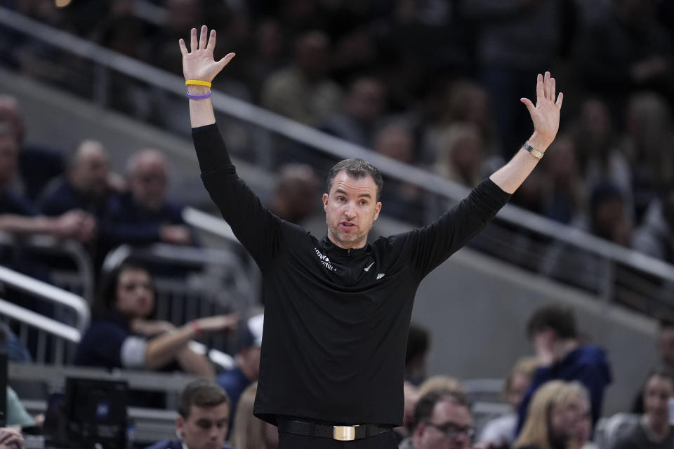 Utah State head coach Danny Sprinkle directs his team in the second half of a first-round college basketball game against TCU in the NCAA Tournament, Friday, March 22, 2024, in Indianapolis. (AP Photo/Michael Conroy)
