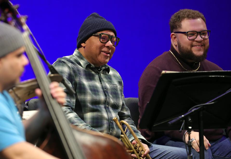 Trumpeter Wynton Marsalis, center, shares a laugh with Juilliard trumpeter Nathaniel Williford, right, in the Jazz at Lincoln Center Orchestra during a sound check before a performance at EJ Thomas Hall, Saturday, April 20, 2024, in Akron, Ohio. At left is bass player Carlos Henriquez.