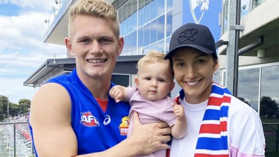 Adam Treloar is pictured here with his wife and daughter at Whitten Oval.