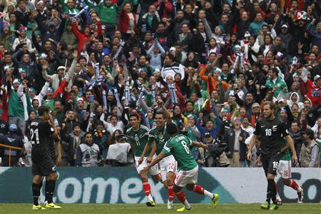 Mexico's Paul Aguilar (C) celebrates his goal with Raul Jimenez (L) and Juan Medina during their 2014 World Cup qualifying playoff first leg soccer match against New Zealand at Azteca stadium in Mexico City November 13, 2013. REUTERS/Edgard Garrido