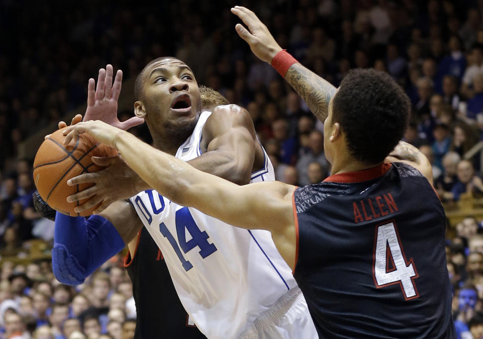 Duke's Rasheed Sulaimon (14) looks to pass as Maryland's Seth Allen (4) and Evan Smotrycz, rear, defend during the first half of an NCAA college basketball game in Durham, N.C., Saturday, Feb. 15, 2014. (AP Photo/Gerry Broome)