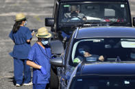 Health care workers administer COVID-19 tests at a drive-through clinic in Sydney, Friday, Dec. 31, 2021. Australian health authorities have reported a record 32,000 new virus cases, many of them in Sydney. (Bianca De Marchi/AAP Image via AP)