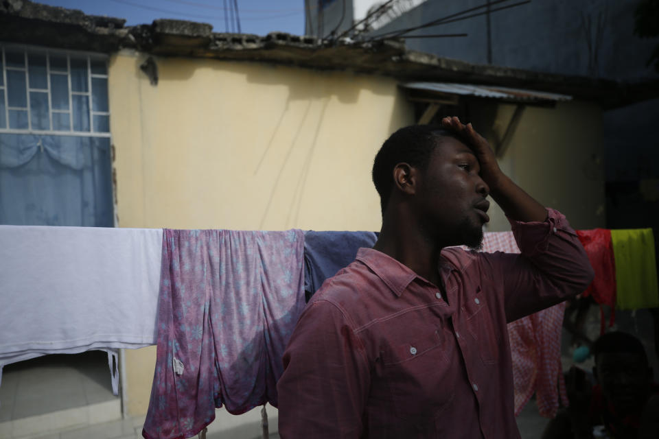 Entrepreneur and youth leader Pascéus Juvensky St. Fleur, 26, walks in the courtyard of his family's home in the Delmas neighborhood of Port-au-Prince, Haiti, Tuesday, Oct. 8, 2019. St. Fleur says the protests are not only about replacing a president, but changing a system. "It's not one person, it's not one regime, it's not a president, it's not the opposition, it's not the bourgeoisie, but it's us who should do it," he said. "We dream of, and we want, a better Haiti." (AP Photo/Rebecca Blackwell)