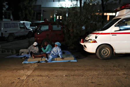 Hospital workers rest outside of a hospital in Port-de-Paix, Haiti October 7, 2018 after an earthquake hit northern Haiti late on Saturday. REUTERS/Ricardo Rojas