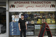 Afghanistan's Nassrullah Youssoufi poses at a grocery store in Paris, Friday, Sept. 10, 2021. Youssoufi started life in France in the streets after a harrowing journey out of Afghanistan that included three months in detention in Hungary for illegal entry. When not at his day job in the asylum court and his studies for a law degree, Youssoufi, who now has French nationality, holds court himself at the Afghan Market, a grocery store in northern Paris, where he helps Afghans in exile seeking guidance or translations of official documents. (AP Photo/Rafael Yaghobzadeh)