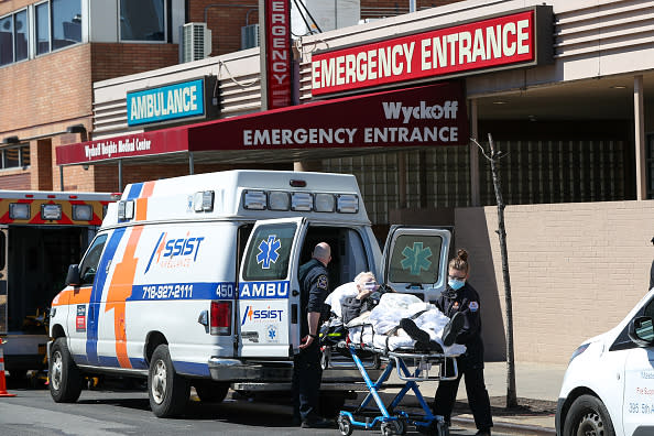 Healthcare workers help a patient at the Wyckoff Heights Medical Center in Brooklyn, New York City.