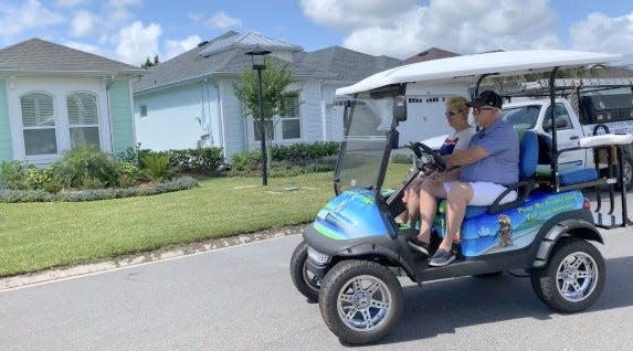 Keith and Cindy Hardin of Colorado Springs drive their golf cart to their newly purchased home at Daytona Beach's Latitude Margaritaville 55-and-older community in May 2021. Such communities have enhanced the area's appeal to retirees. Daytona Beach was listed at No. 7 in U.S. News & World Report's 2022-23 ranking of Best Places to Retire.