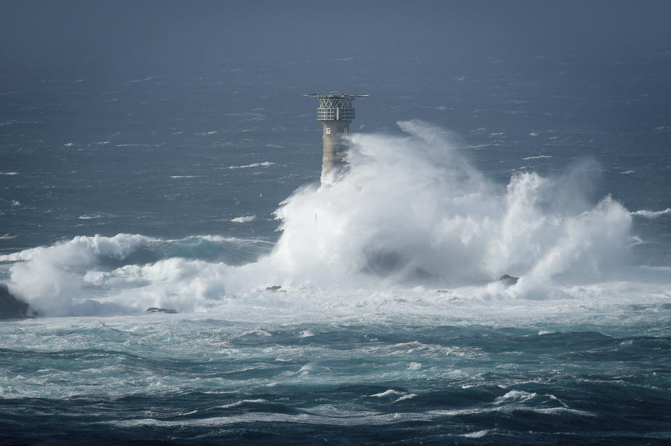 <p>Waves break on Longships lighthouse off the coast of Lands End, southwestern England. Wind speeds have reached 118mph in Ireland and 77mph in Wales. (Liam McBurney/PA via AP) </p>