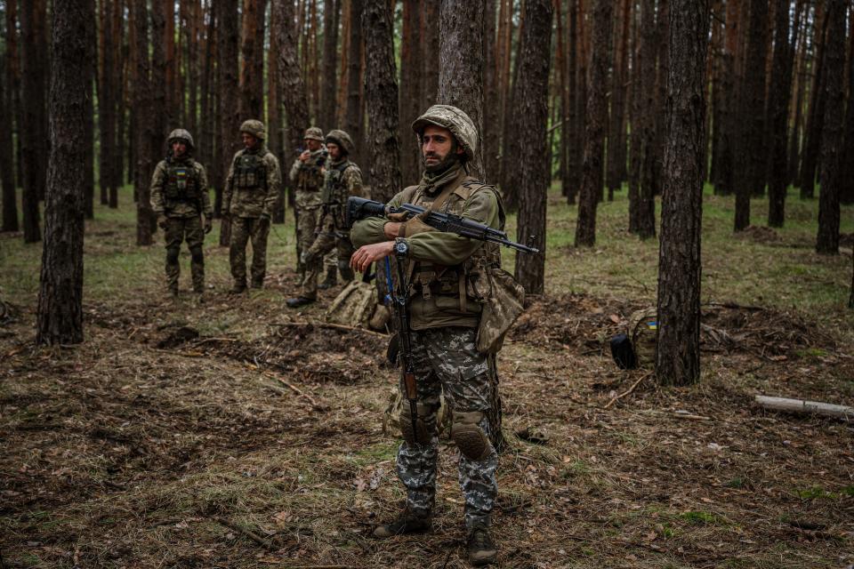 Ukrainian servicemen take part in a military exercise in a forest (AFP via Getty Images)