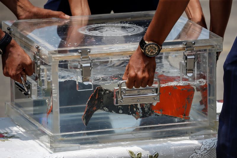 KNKT officials place the Cockpit Voice Recorder (CVR) of Sriwijaya Air flight SJ 182 on a table at Tanjung Priok Port in Jakarta