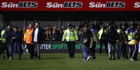 Britain Football Soccer - Sutton United v Arsenal - FA Cup Fifth Round - The Borough Sports Ground - 20/2/17 Sutton fans on the pitch with police officers after the match Reuters / Eddie Keogh Livepic