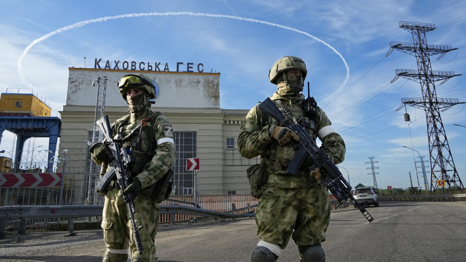 Russian troops guard an entrance of the Kakhovka Hydroelectric Station