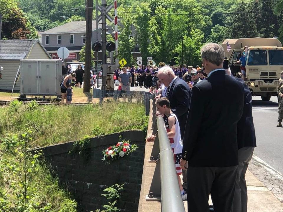 Hawley American Legion Post 311 led the wreath ceremony at the Lackawaxen River Main Avenue bridge in Hawley near the parade's conclusion, May 28. Parker Swanick dropped the wreath honoring U.S. Armed Forces lost at sea. Visible behind him is his grandfather Rick Anke. In the foreground is Congressman Matt Cartwright (PA-08). Henry Schroeder, past Post 311 Commander (not visible) offered remarks.