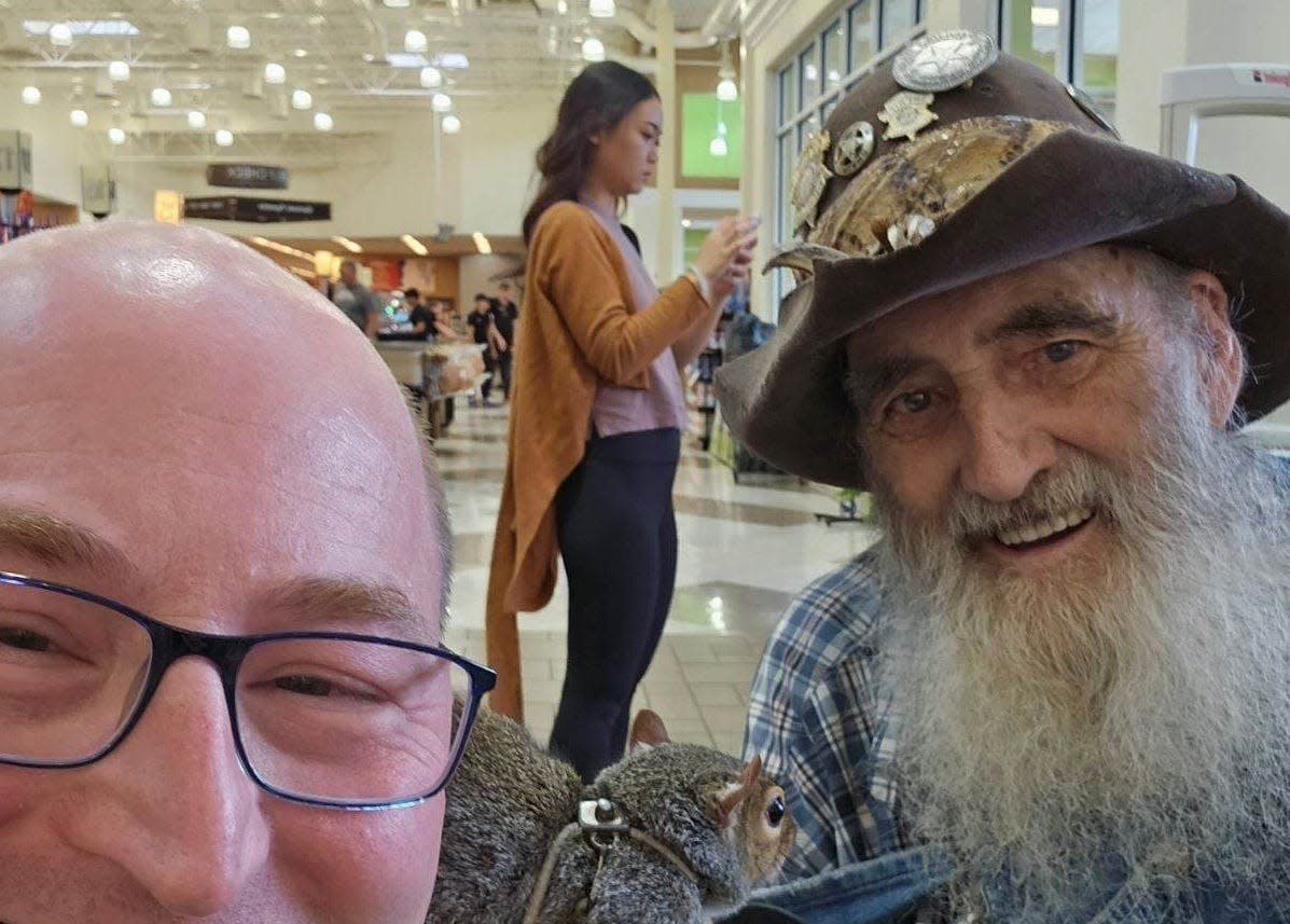 "Deliverance" actor Herbert Coward, right, along with his pet squirrel, poses with Allen Courtney last year at the Ingles in Canton. Coward also appeared on the TV show "Hillbilly Blood."