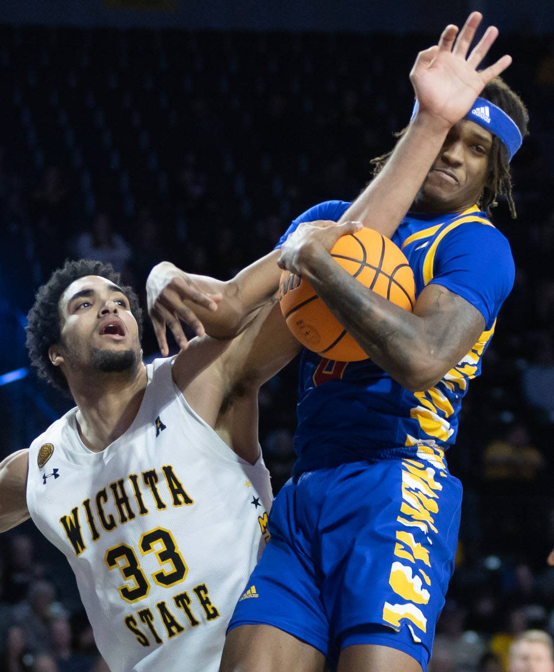 Wichita State’s James Rojas battles Tulsa’s Jesaiah McWright for rebound during the first half of their game on Saturday at Koch Arena.