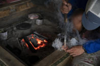 A worker burns a stamp into a souvenir at a mountain hut on Mount Fuji, Monday, Aug. 26, 2019, in Japan. (AP Photo/Jae C. Hong)
