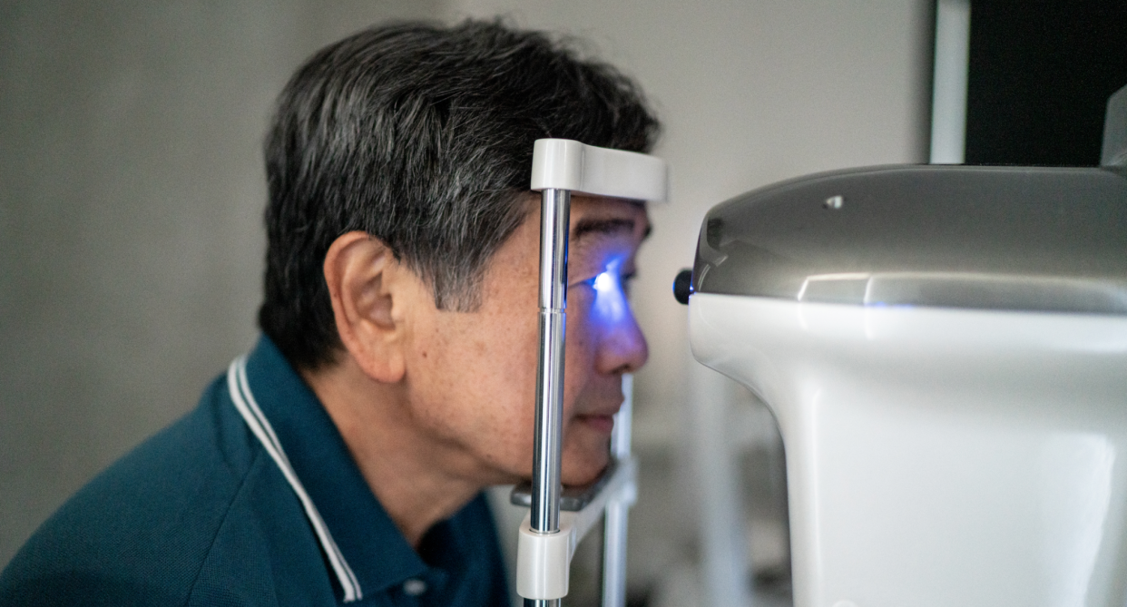 cataracts, old asian man in dark blue polo shirt getting eye exam with laser machine, cataract awareness month